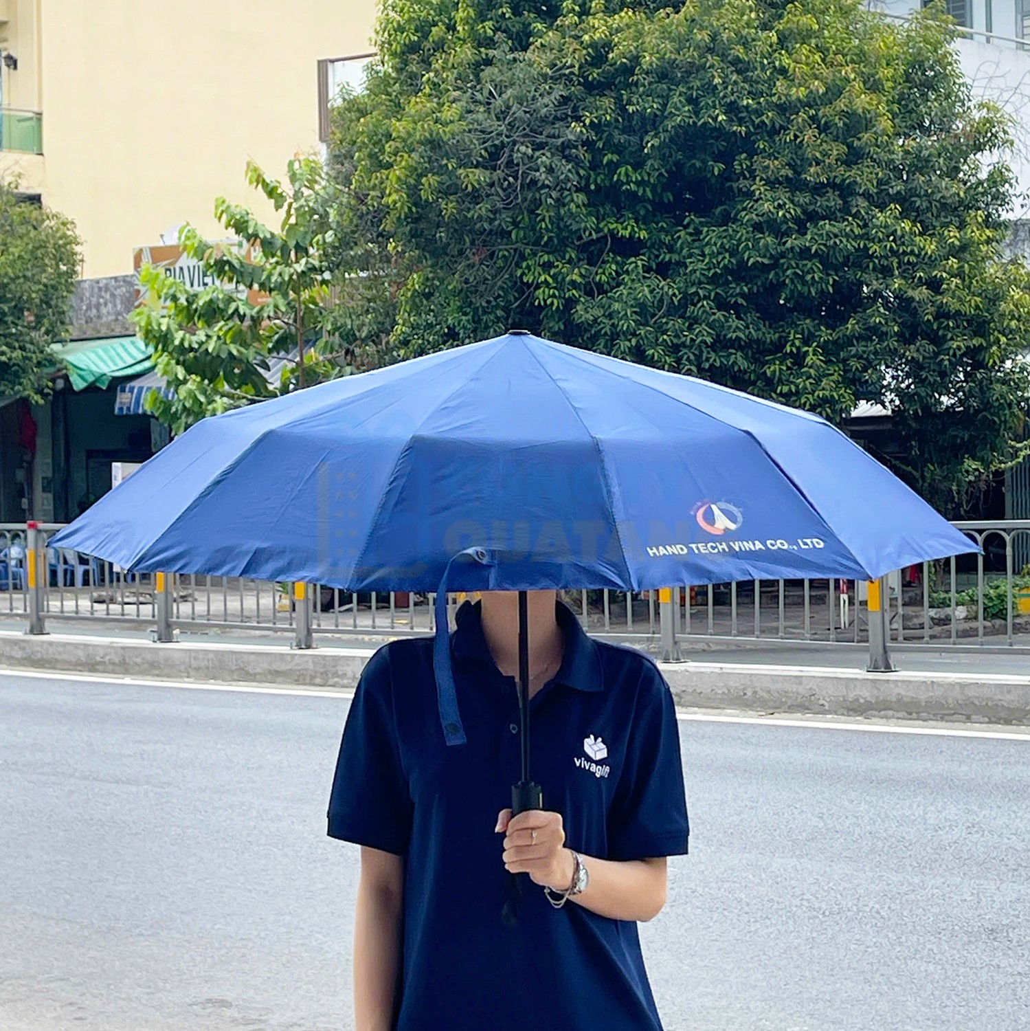 Branded umbrellas protect employees from rain and sun during outdoor team building activities Branded umbrellas protect employees from rain and sun during outdoor team building activities